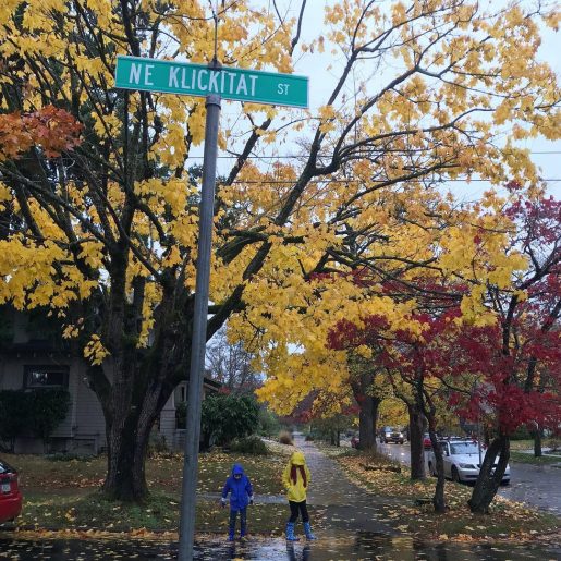 kids in rain slickers under autumn trees