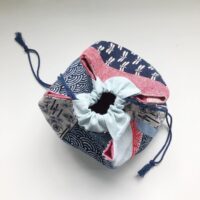 Top view of a handmade drawstring bag in red and blue fabrics