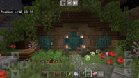 Image of a hobbit hole in Minecraft. Blue doors, brown wood frame, overhanging leaves. I love it so much.