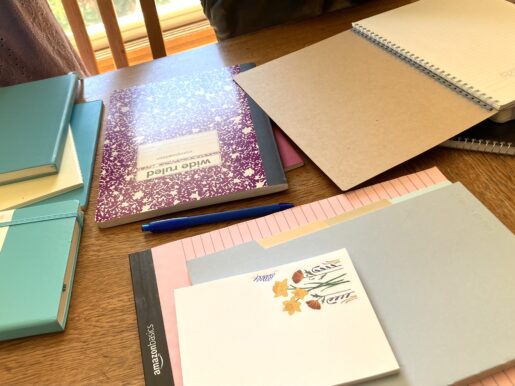 an assortment of notebooks strewn on a table